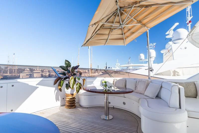 a table and chairs on a balcony aboard GIORGIA I Yacht for Sale