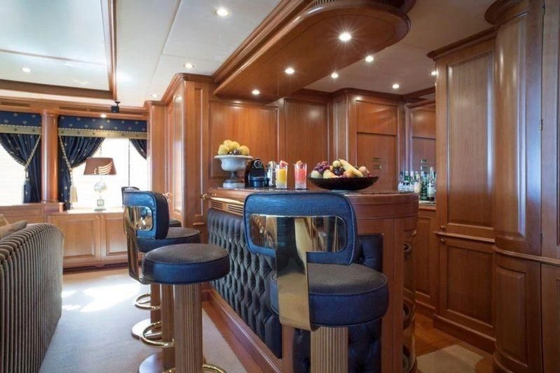 a kitchen with a blue table and chairs aboard GIORGIA I Yacht for Sale