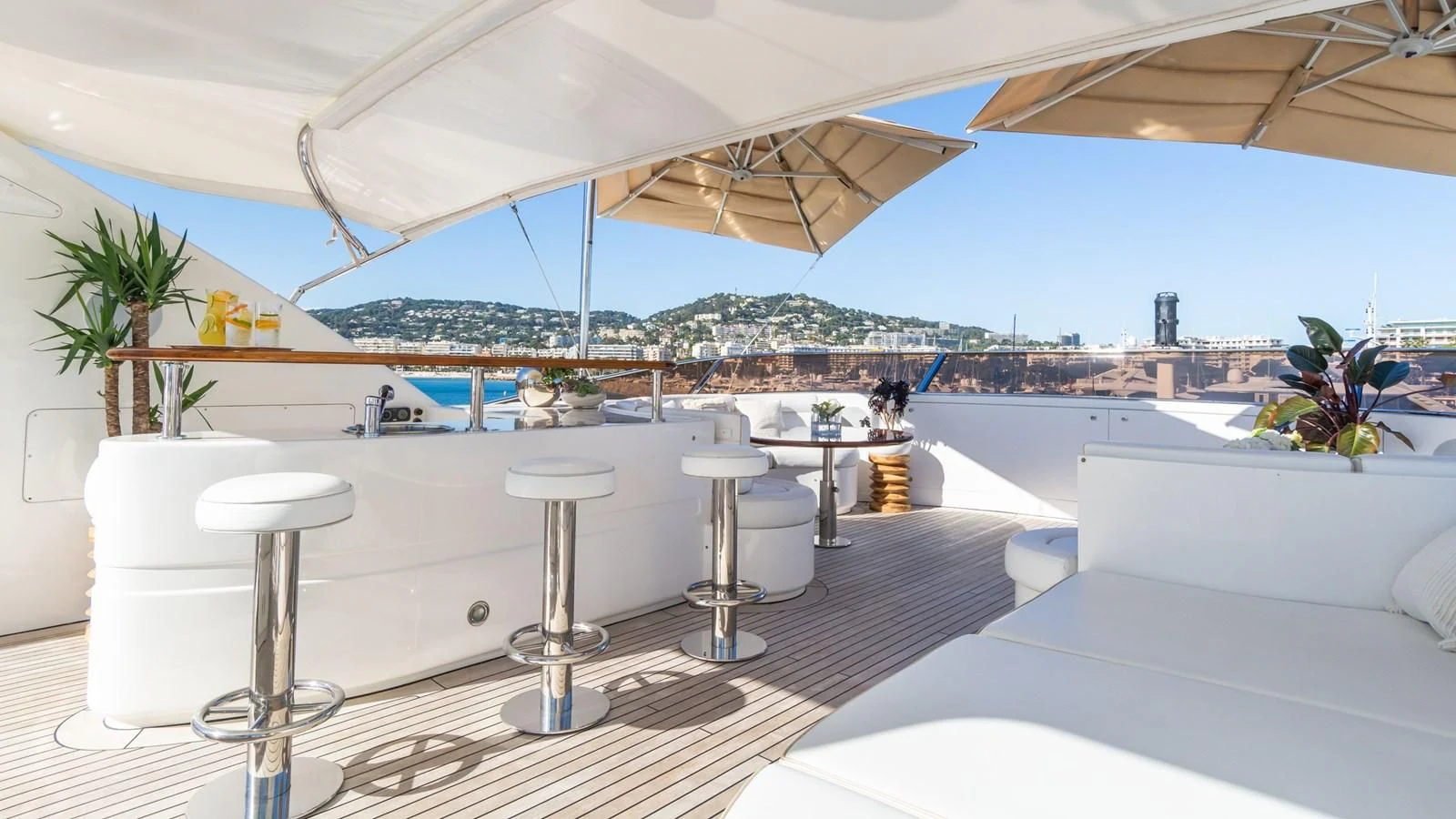 a large white lounge chair next to a large white umbrella aboard GIORGIA I Yacht for Sale