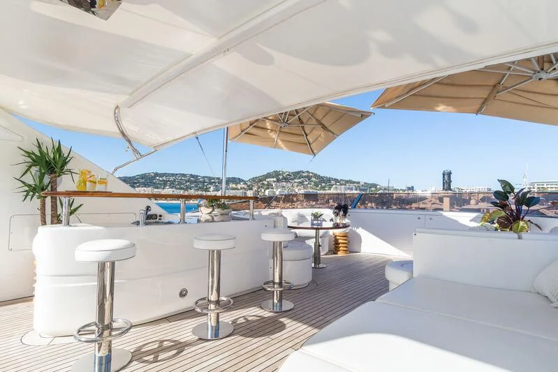 a large white lounge area with a large white table and chairs and a large white umbrella aboard GIORGIA I Yacht for Sale