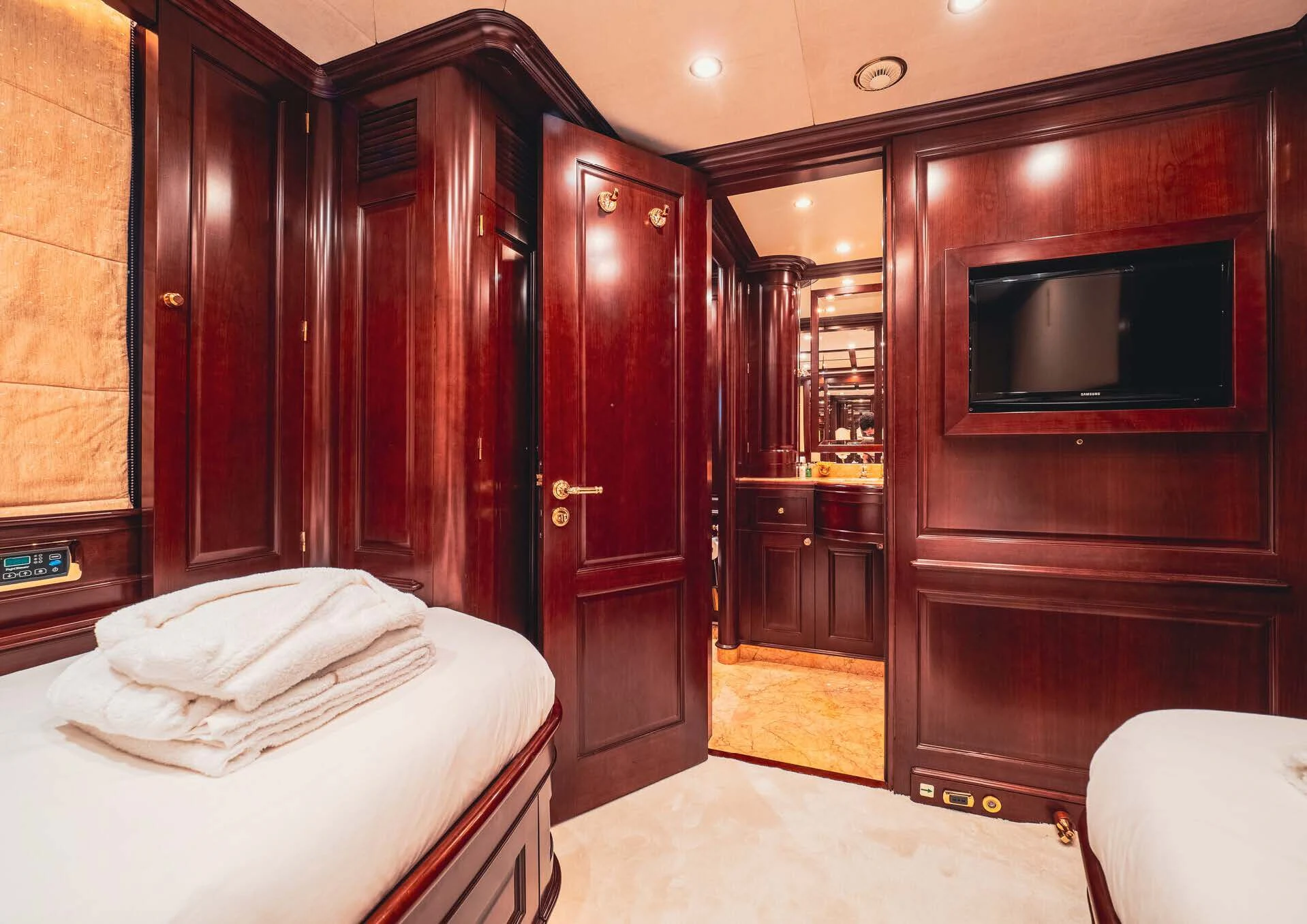 a bedroom with a bed and a television aboard GIORGIA I Yacht for Sale