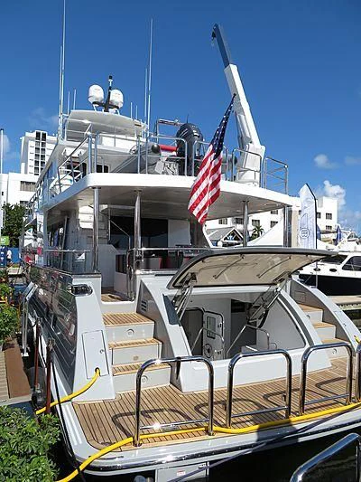 a boat with a flag on the front aboard ICE Yacht for Sale