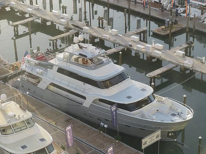 a large boat docked at a pier aboard ICE Yacht for Sale