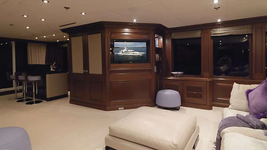 a living room with a tv and couches aboard MY LITTLE VIOLET Yacht for Sale