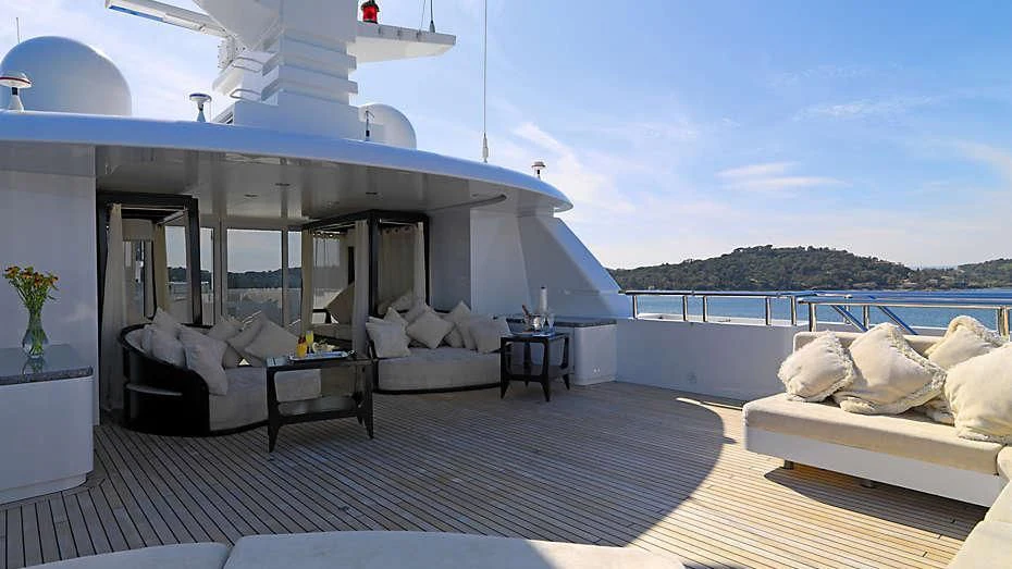a large white boat with a large balcony and a table and chairs aboard MY LITTLE VIOLET Yacht for Sale