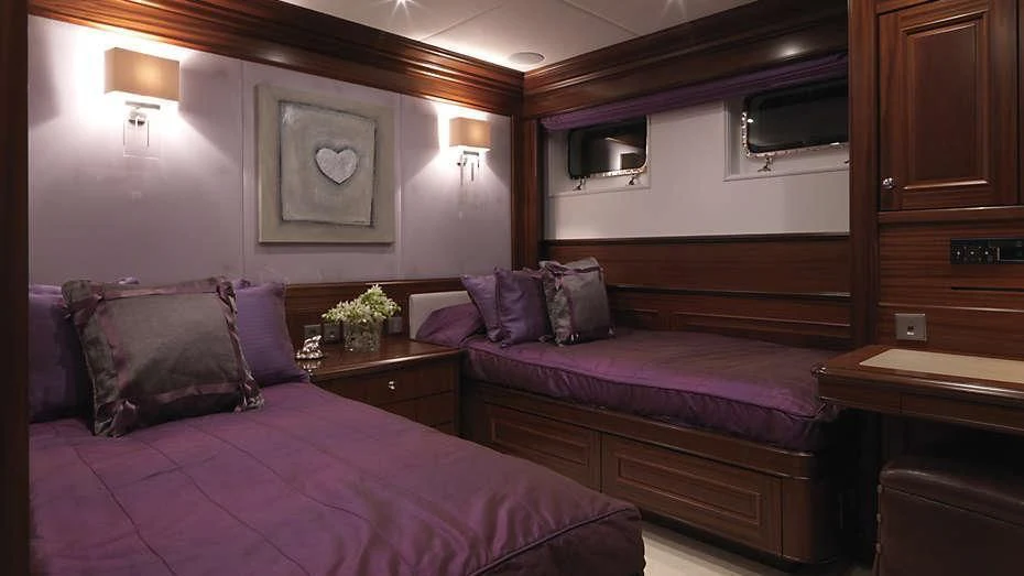 a bedroom with a bed and a desk aboard MY LITTLE VIOLET Yacht for Sale