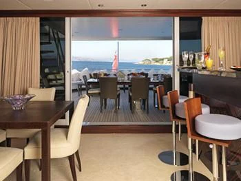 a room with tables and chairs aboard MY LITTLE VIOLET Yacht for Sale
