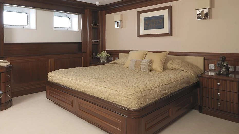 a bed with a brown comforter aboard MY LITTLE VIOLET Yacht for Sale