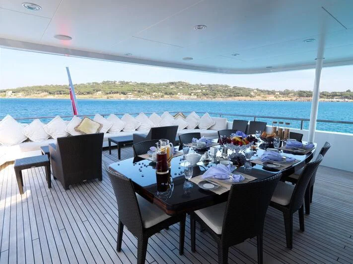 a table set for a dinner aboard MY LITTLE VIOLET Yacht for Sale