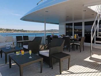 a patio with a table and chairs aboard MY LITTLE VIOLET Yacht for Sale