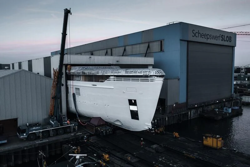 a large container ship docked aboard PROMISE.D Yacht for Sale