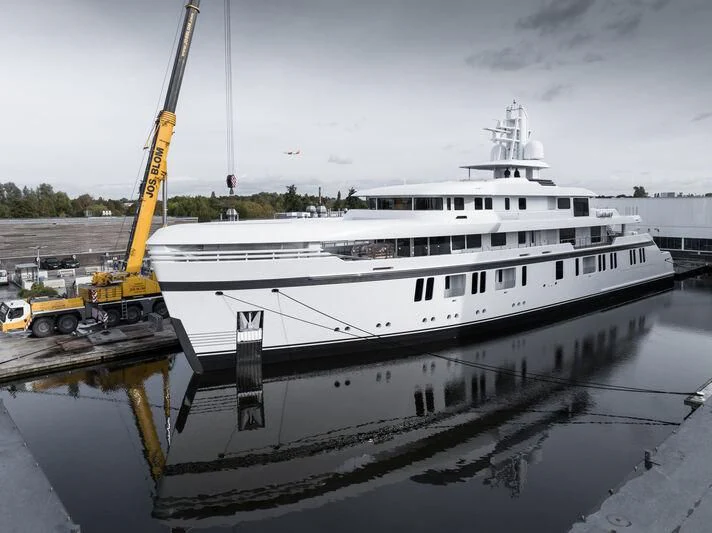 a large white boat docked at a dock aboard PROMISE.D Yacht for Sale