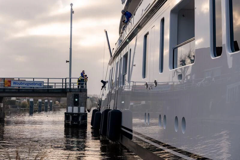 a person standing on a boat in the water aboard PROMISE.D Yacht for Sale