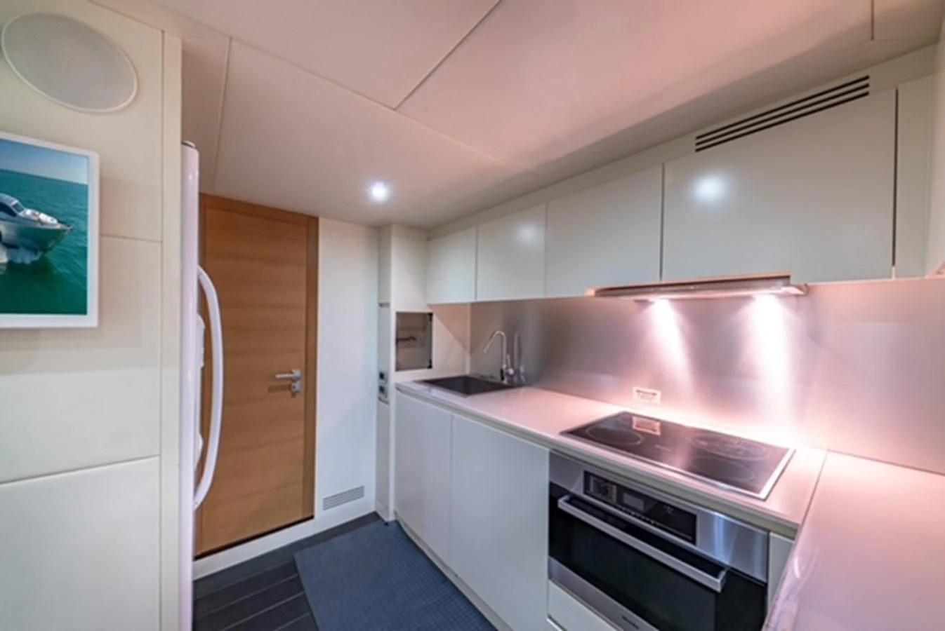 a kitchen with a pink counter aboard WRAITH Yacht for Sale