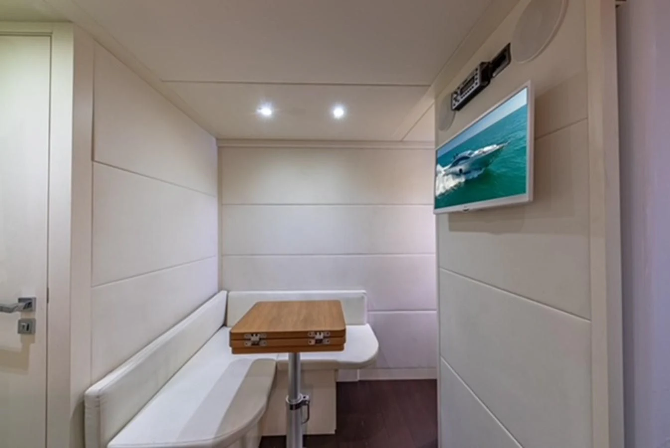 a small bathroom with a small television on the wall aboard WRAITH Yacht for Sale