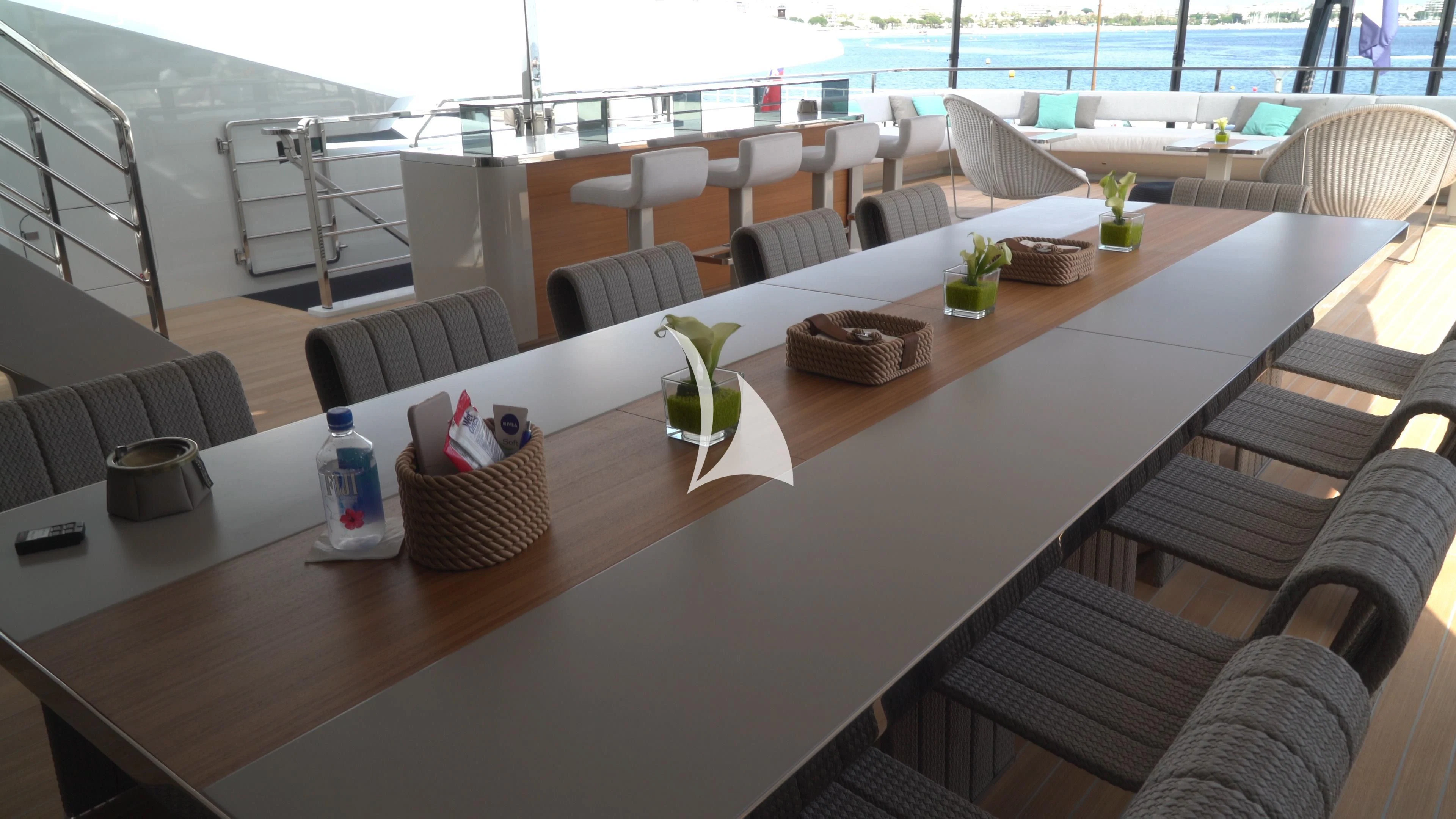 a table with chairs and a pool aboard UTOPIA IV Yacht for Sale