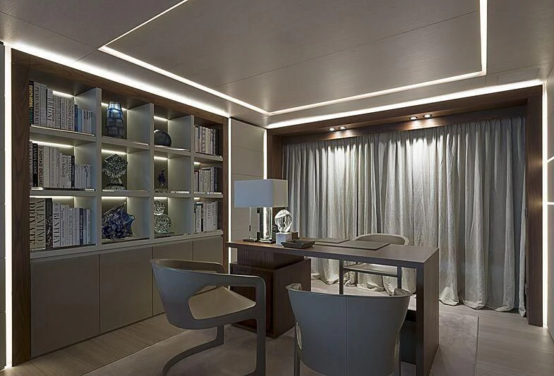 a room with a bookcase and a desk aboard UTOPIA IV Yacht for Sale
