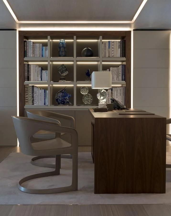 a book shelf with a chair and a desk aboard UTOPIA IV Yacht for Sale