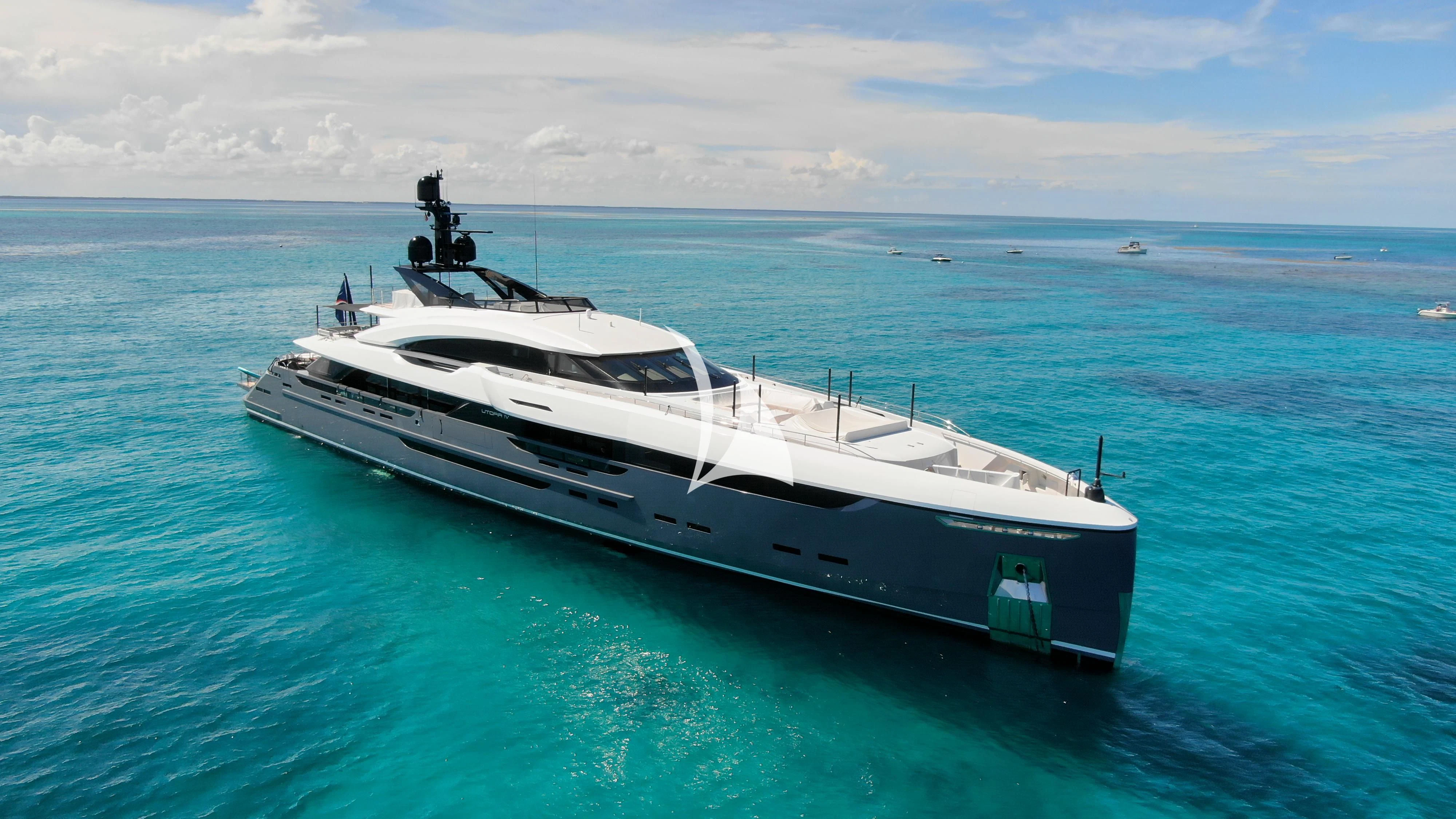 a white yacht in the water aboard UTOPIA IV Yacht for Sale