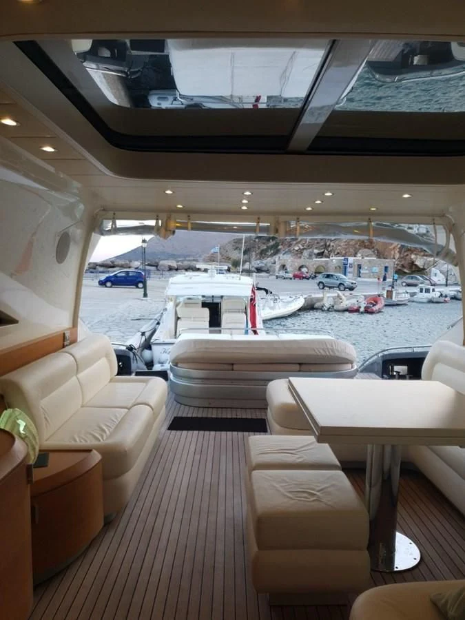 a boat with a deck and chairs aboard FOX Yacht for Sale