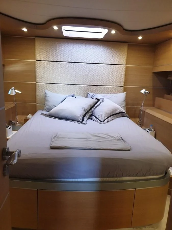 a bed with a white comforter aboard FOX Yacht for Sale