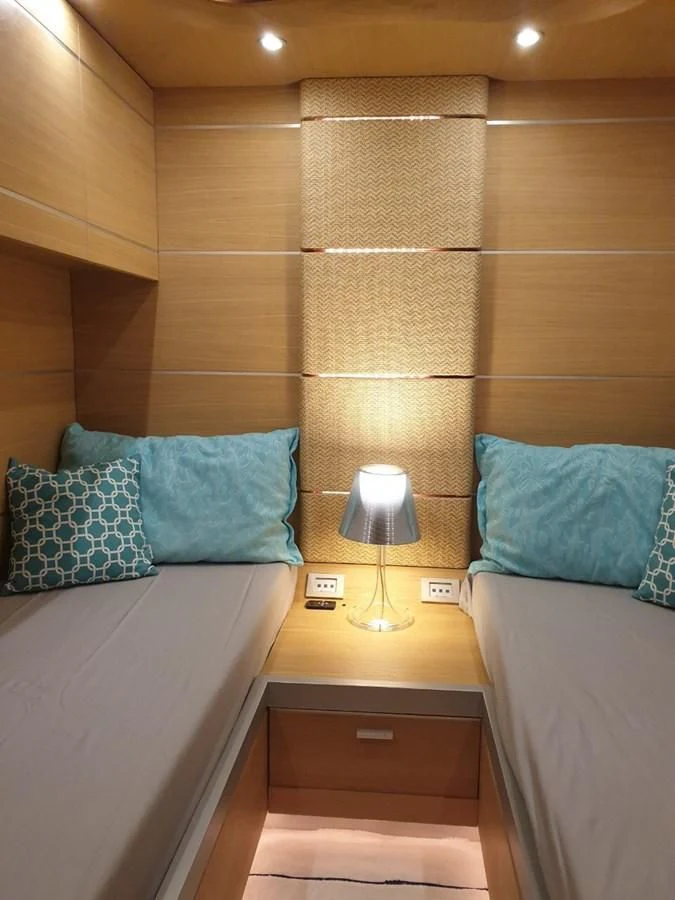 a bed with a blue pillow aboard FOX Yacht for Sale