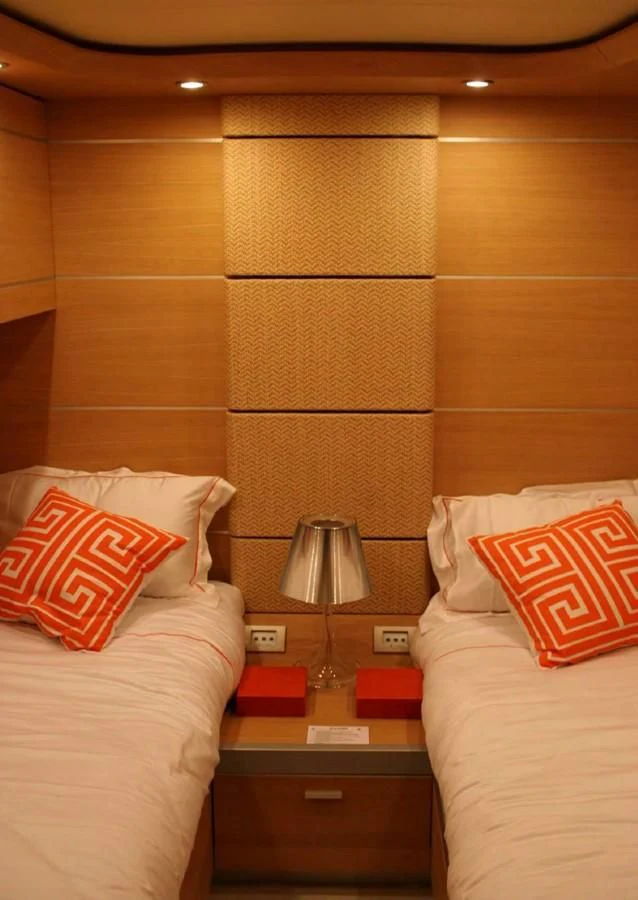 a bed with a pillow and a lamp on it aboard FOX Yacht for Sale