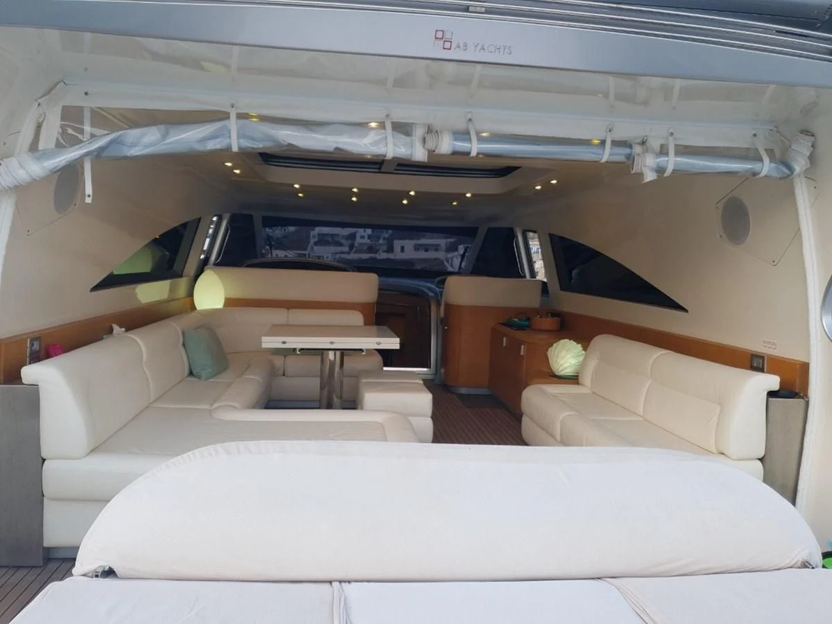 a room with a couch and a table aboard FOX Yacht for Sale