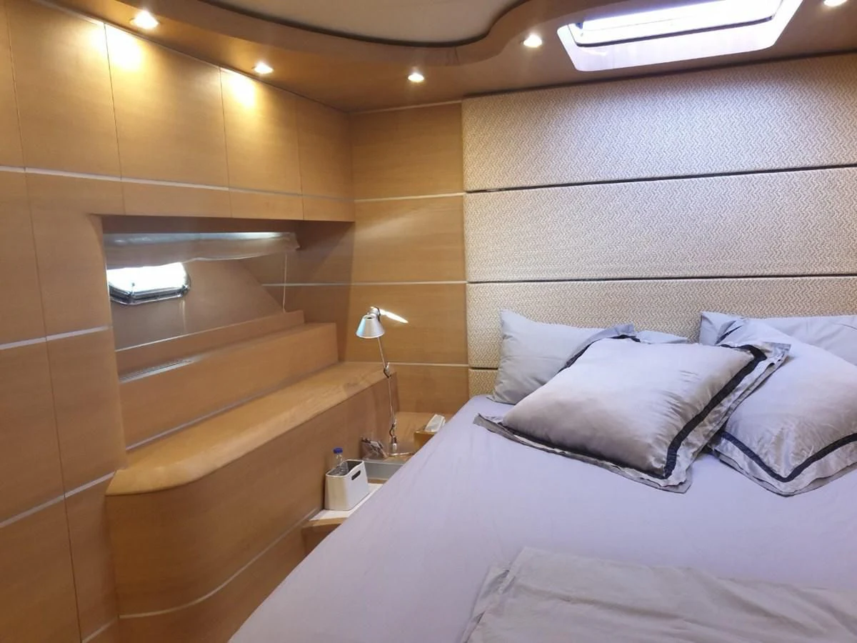 a bed with a white bed spread aboard FOX Yacht for Sale