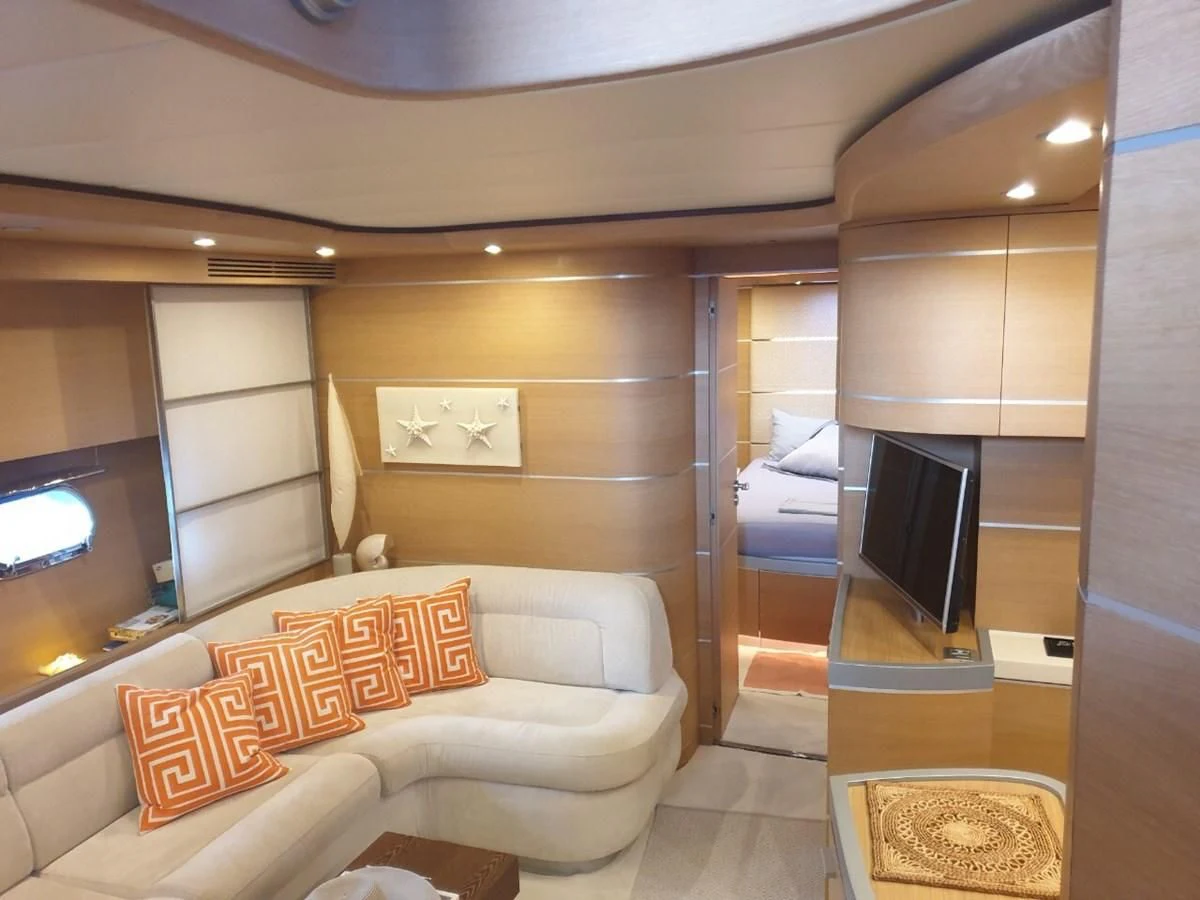 a room with a couch and a television aboard FOX Yacht for Sale