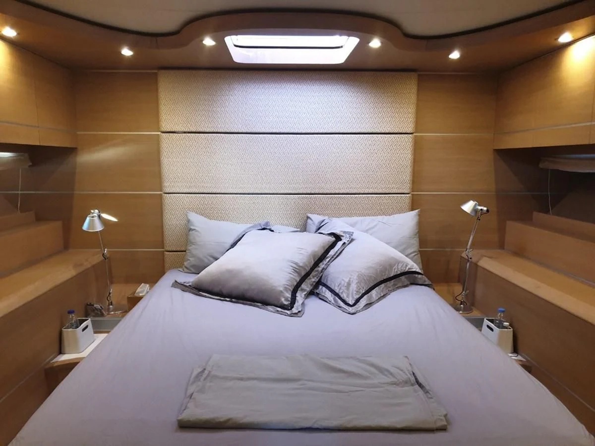 a bed with white sheets aboard FOX Yacht for Sale