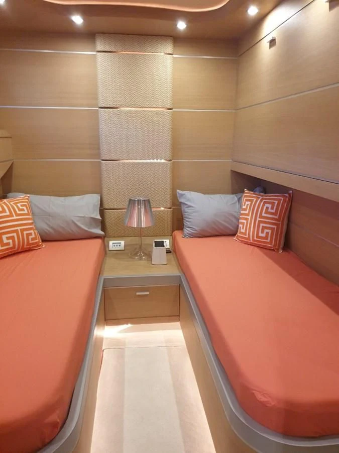 a room with a bed and a lamp aboard FOX Yacht for Sale