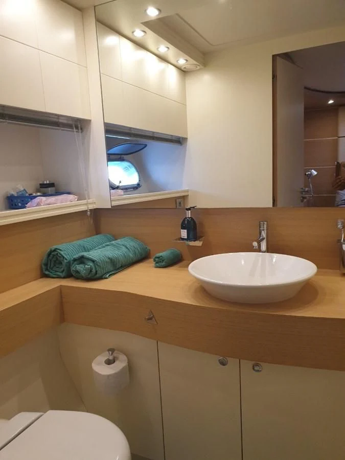 a bathroom with a sink and a mirror aboard FOX Yacht for Sale