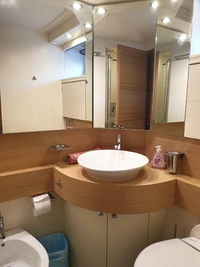 a bathroom with a sink and a mirror aboard FOX Yacht for Sale