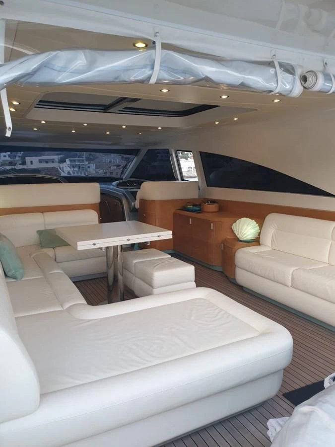 a room with a couch and a table aboard FOX Yacht for Sale