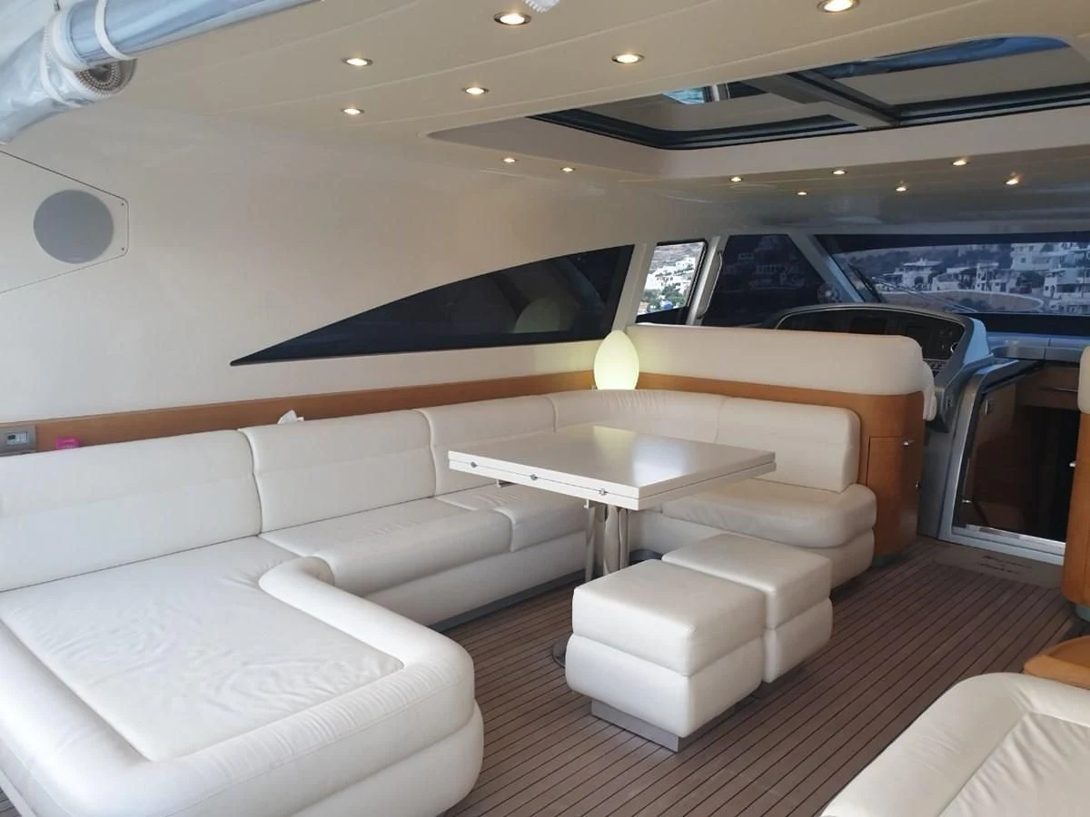 a room with a couch and a table aboard FOX Yacht for Sale