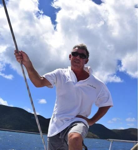 a man holding a bow and arrow aboard LUNA DANNS Yacht for Sale