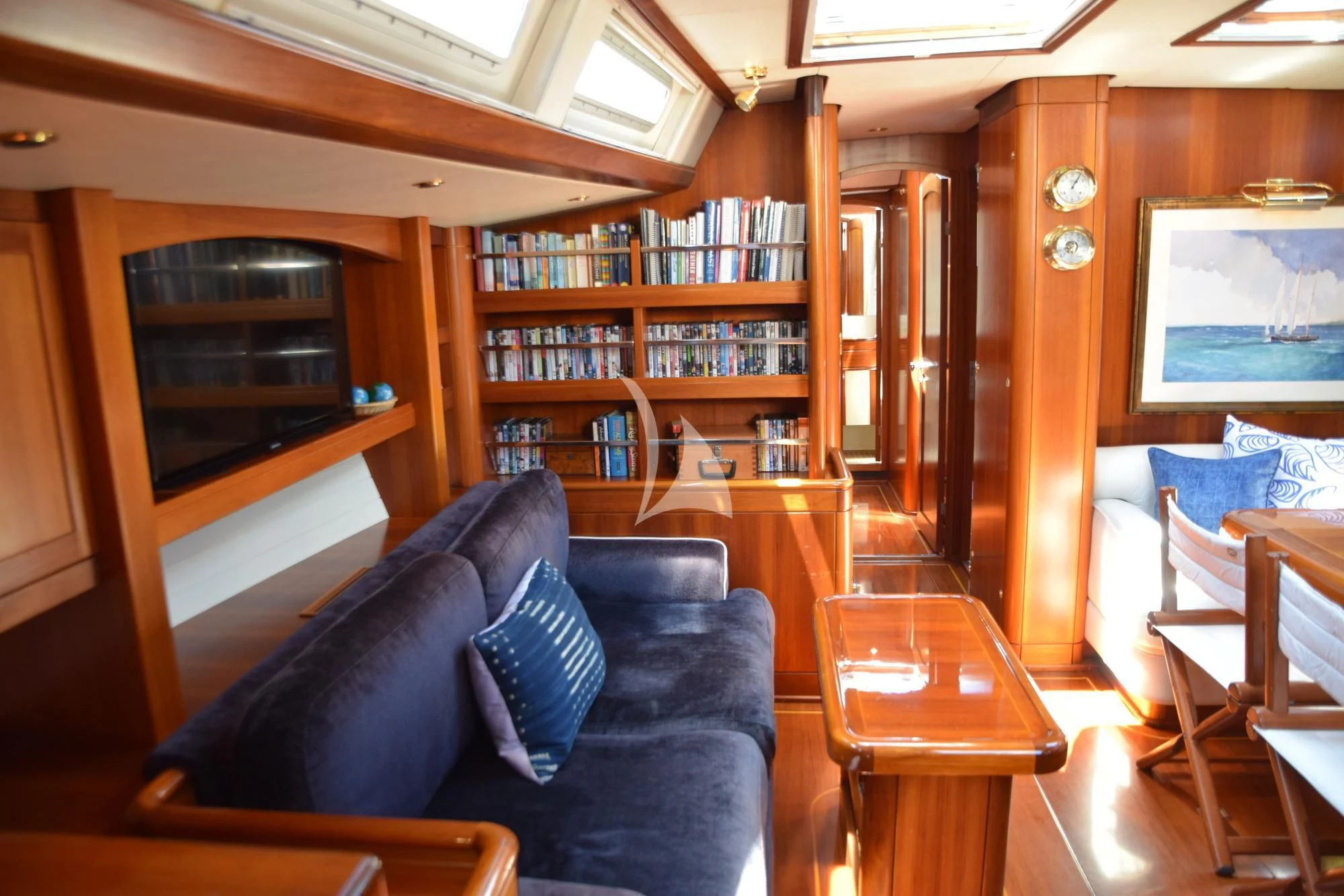 a living room with a blue couch aboard LUNA DANNS Yacht for Sale