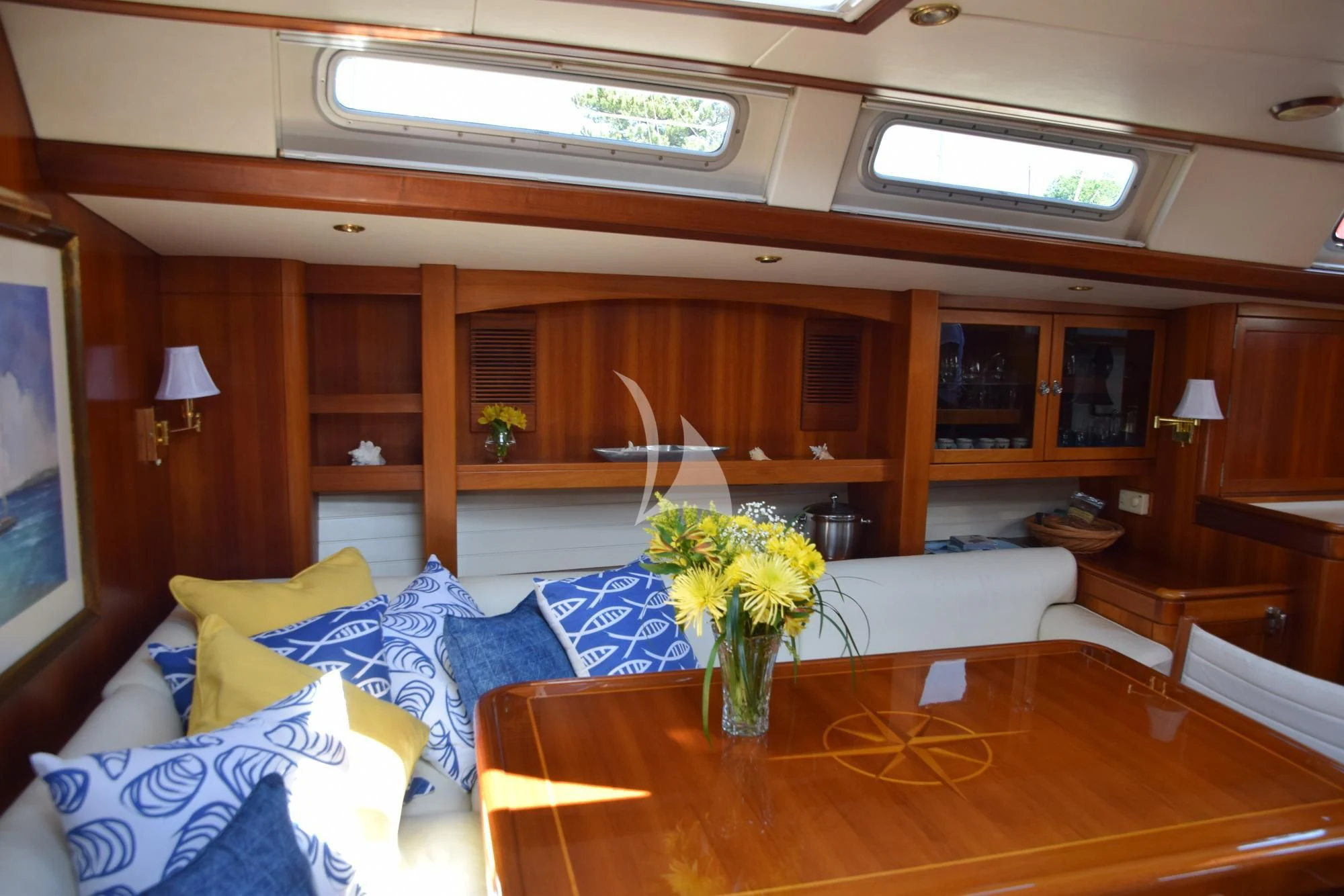 a living room with a table and couches aboard LUNA DANNS Yacht for Sale