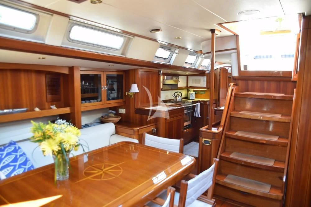 a room with wooden stairs and a vase of flowers aboard LUNA DANNS Yacht for Sale