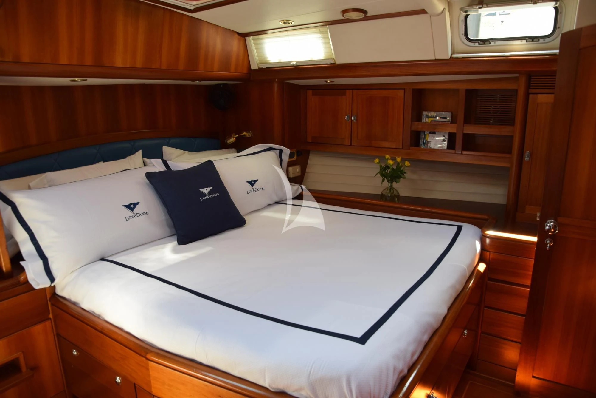a bed with white sheets and pillows aboard LUNA DANNS Yacht for Sale