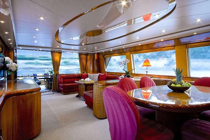 a room with a table and chairs aboard IMPORTANT BUSINESS Yacht for Sale