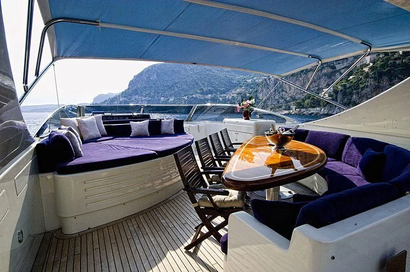 a boat with a table and chairs aboard IMPORTANT BUSINESS Yacht for Sale