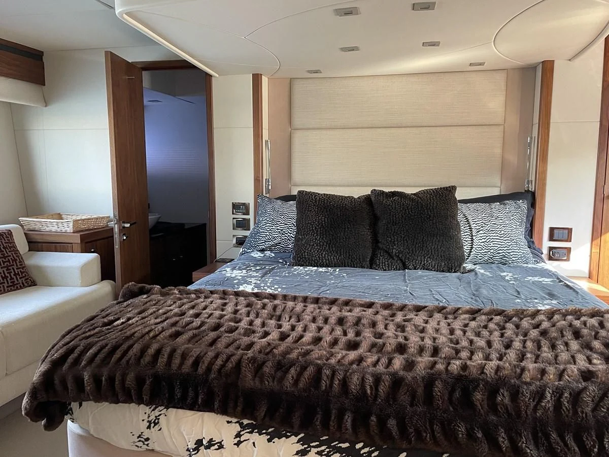 a bed with blue sheets aboard MOONLIGHT DRIVE Yacht for Sale