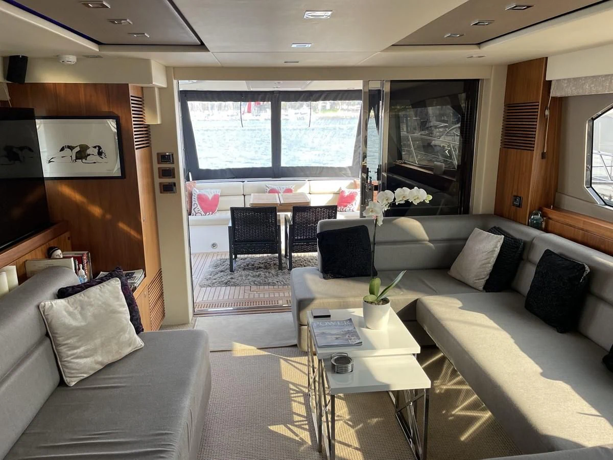 a living room with a couch and a table aboard MOONLIGHT DRIVE Yacht for Sale