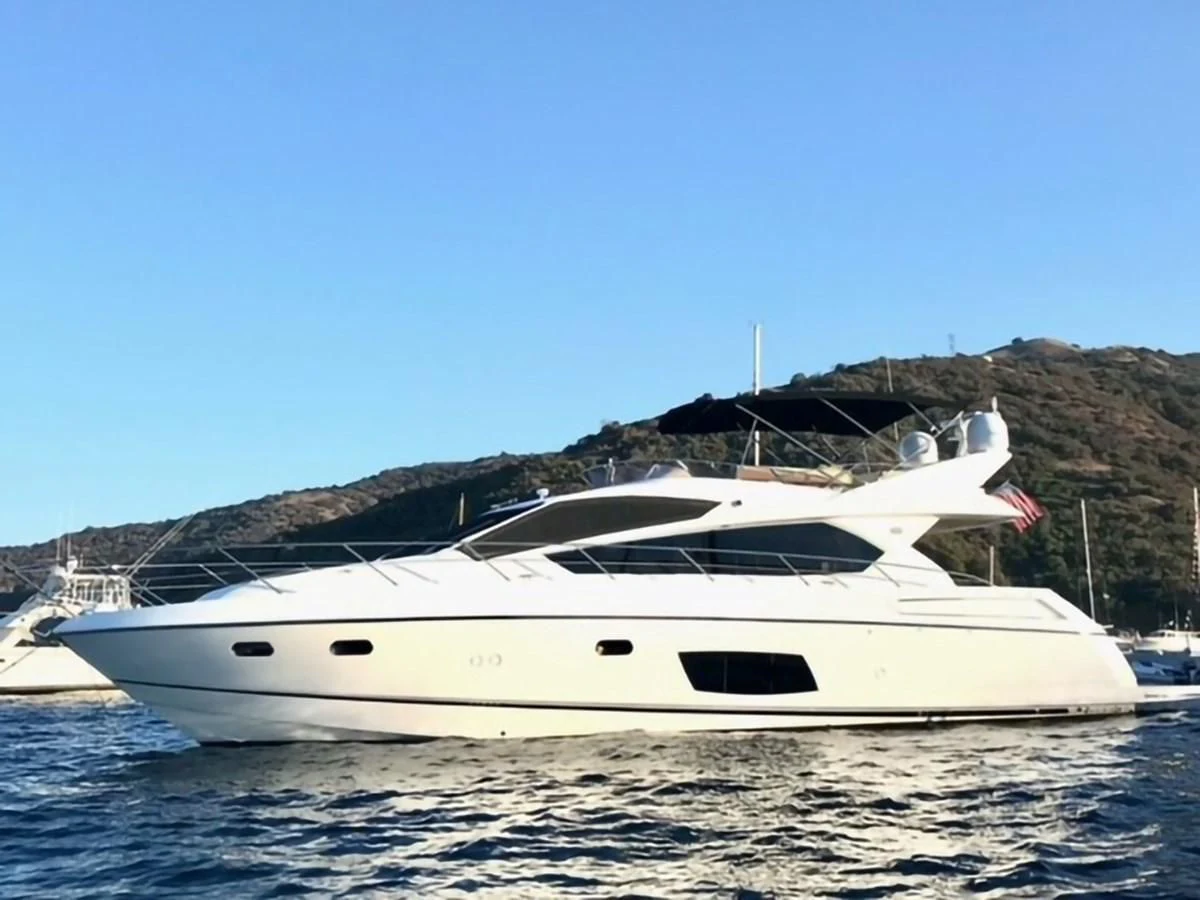 a white yacht on a body of water aboard MOONLIGHT DRIVE Yacht for Sale