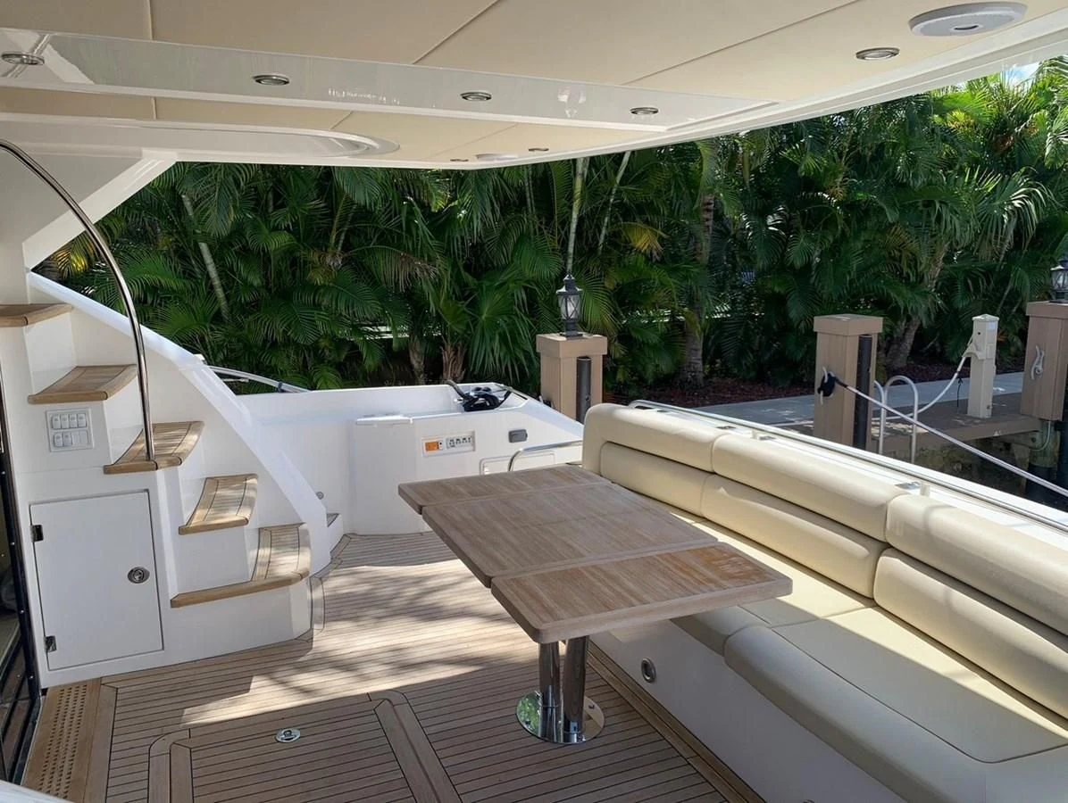 a room with white tables and white cabinets and trees aboard MOONLIGHT DRIVE Yacht for Sale