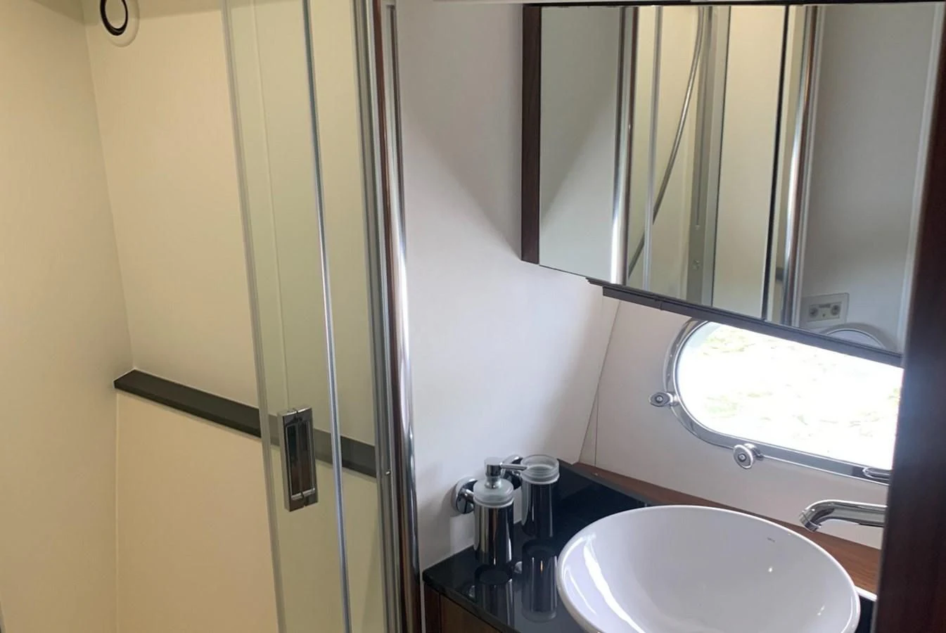 a bathroom with a sink and a mirror aboard MOONLIGHT DRIVE Yacht for Sale