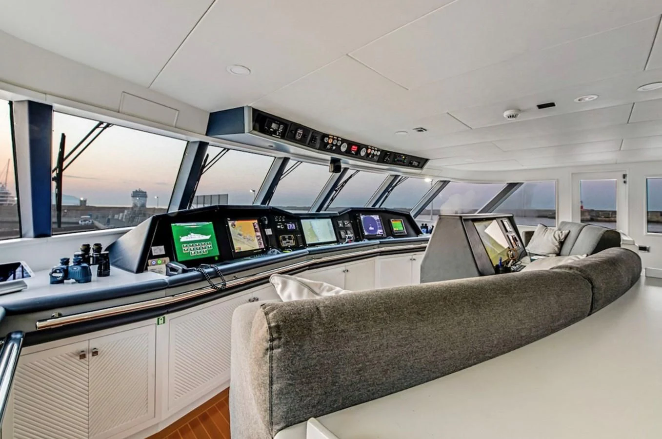 a room with a couch and a computer on the desk aboard BG Yacht for Sale