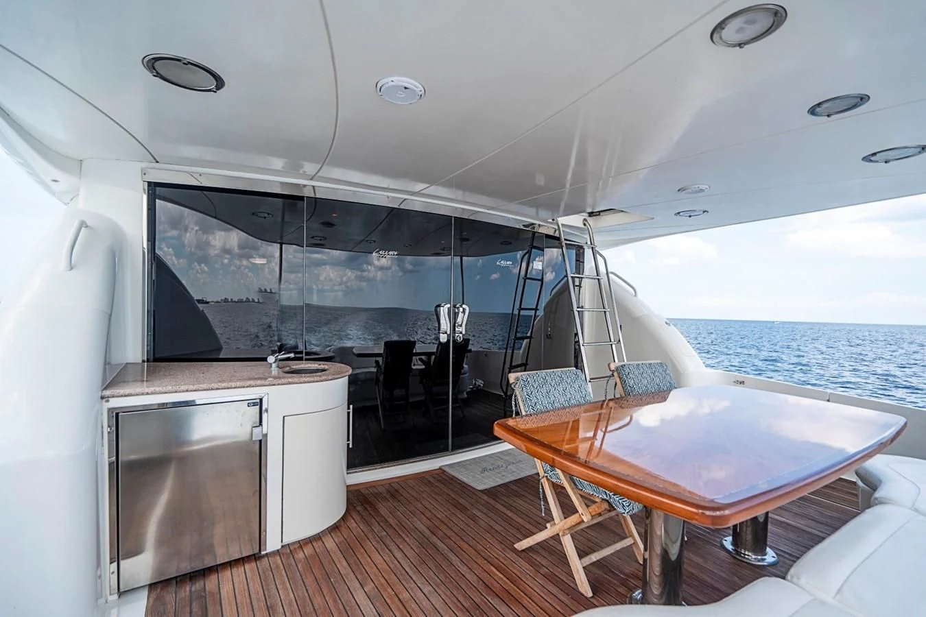 a large living room with a large glass wall aboard RENDEZVOUS Yacht for Sale